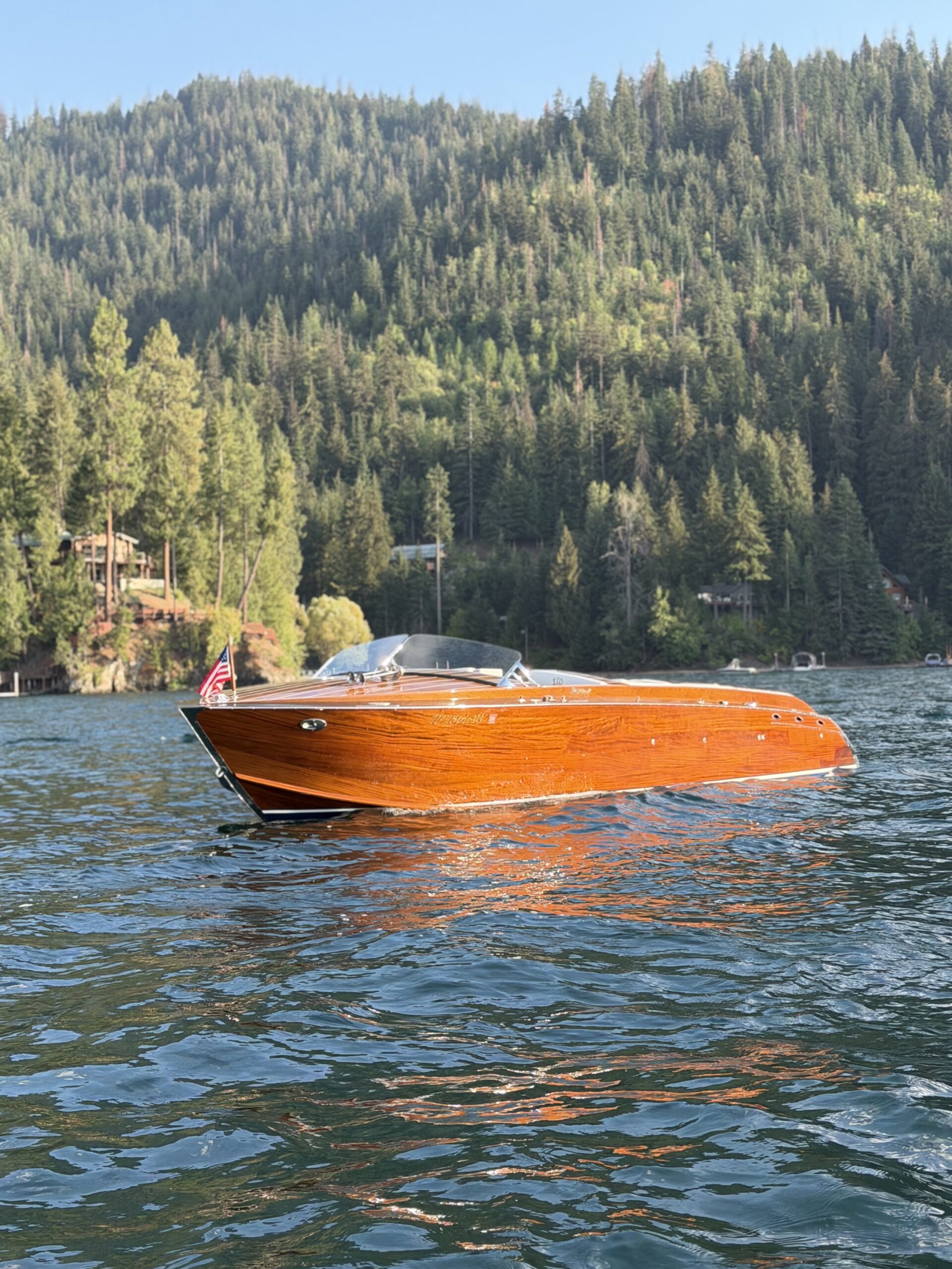 2015 StanCraft 28' Highboy wooden boat on the lake, bow quarter view